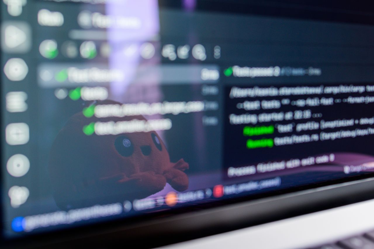 Mastering the First Impression: Your intriguing post title goes here Close-up of a laptop screen displaying programming code with a cute plush toy reflecting.