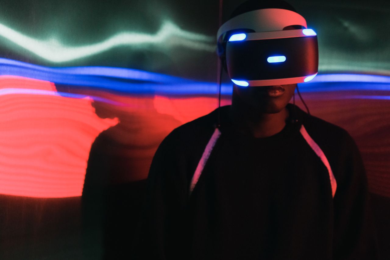 The Art of Drawing Readers In: Your attractive post title goes here Person wearing a virtual reality headset with vibrant light trails in the background.